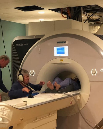 A participant receives reflexology during an fMRI brain scan